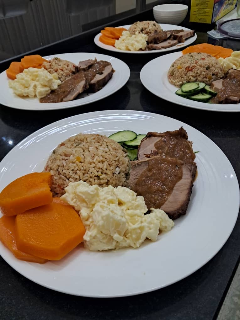 A table of plated meals catered by Topsy's Cuisine